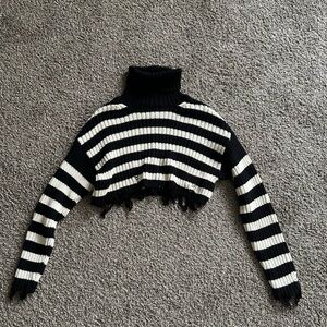 Cropped distressed turtleneck sweater
